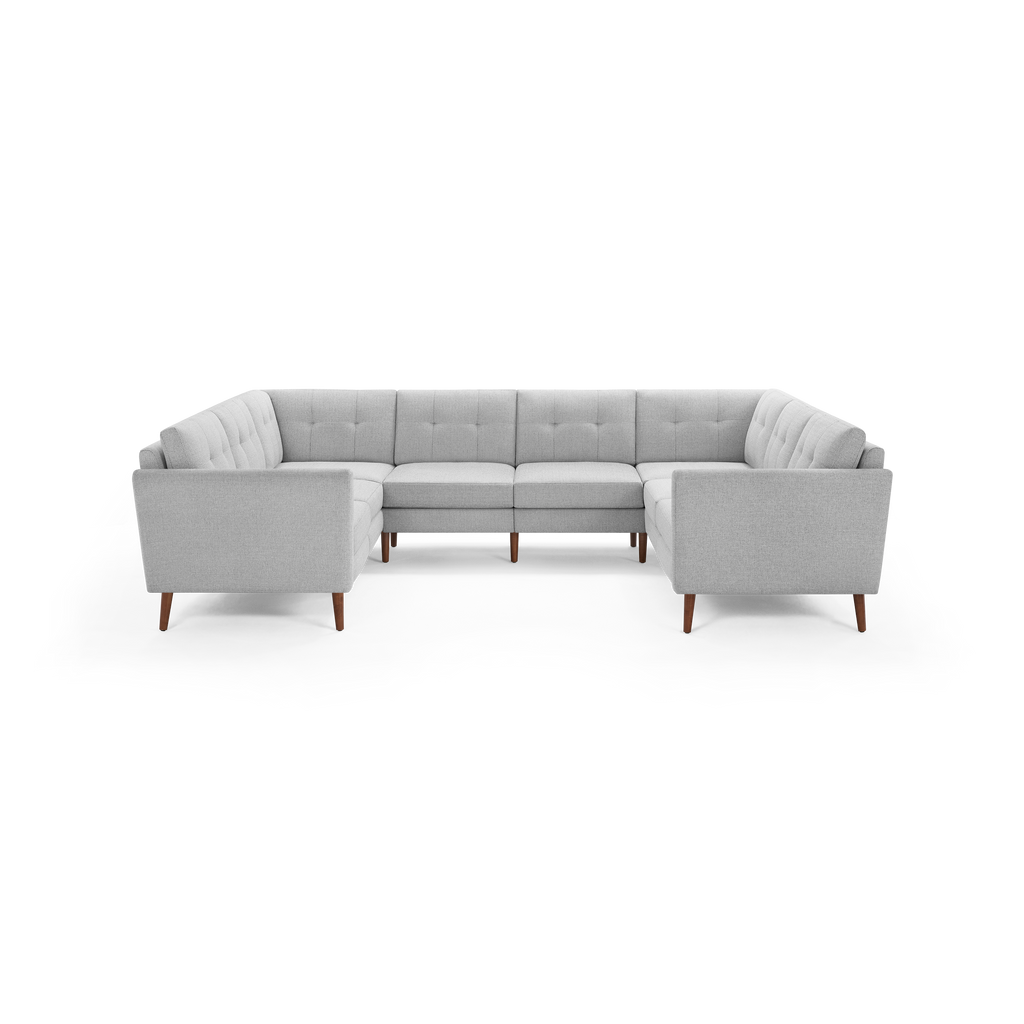 Light gray tufted fabric U-shaped sectional sofa with wooden tapered legs, mid-century modern design, spacious seating.