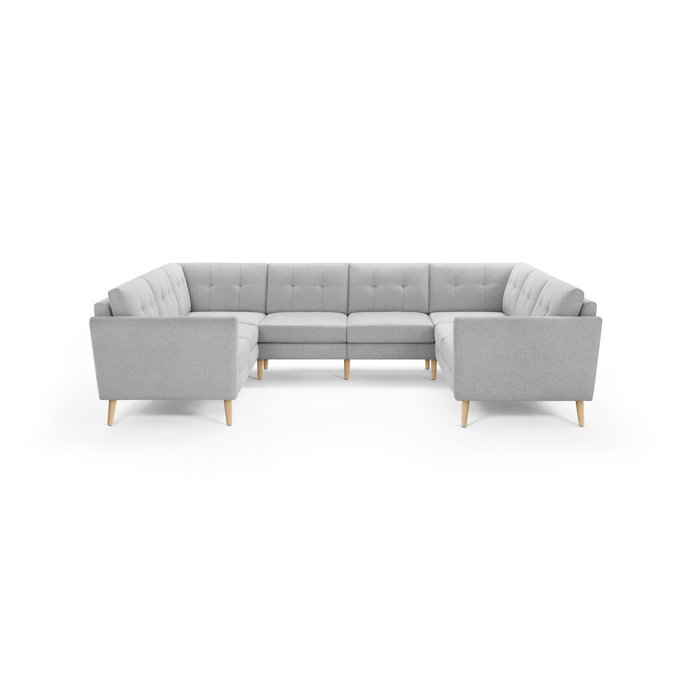 Light gray U-shaped sectional sofa with tufted back cushions and light wooden legs, designed for spacious seating.