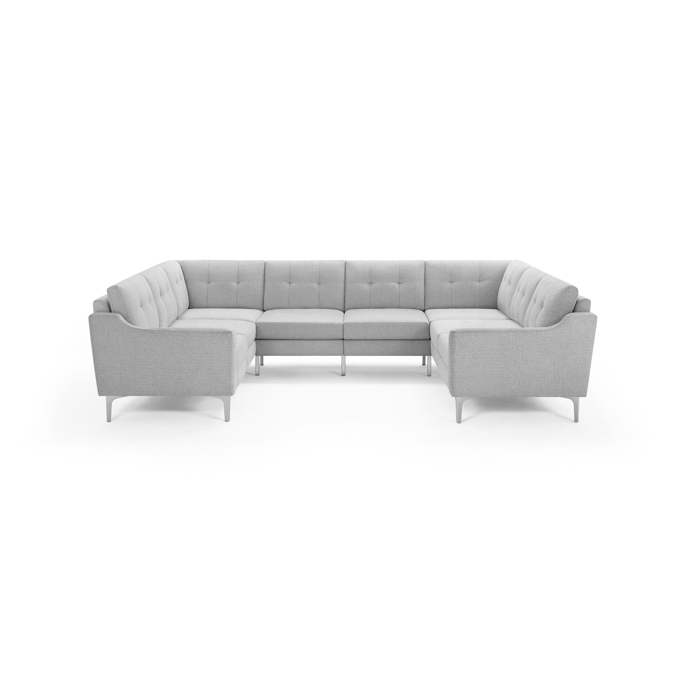 Light gray fabric U-shaped sectional sofa with tufted cushions and slim metal legs against black background.