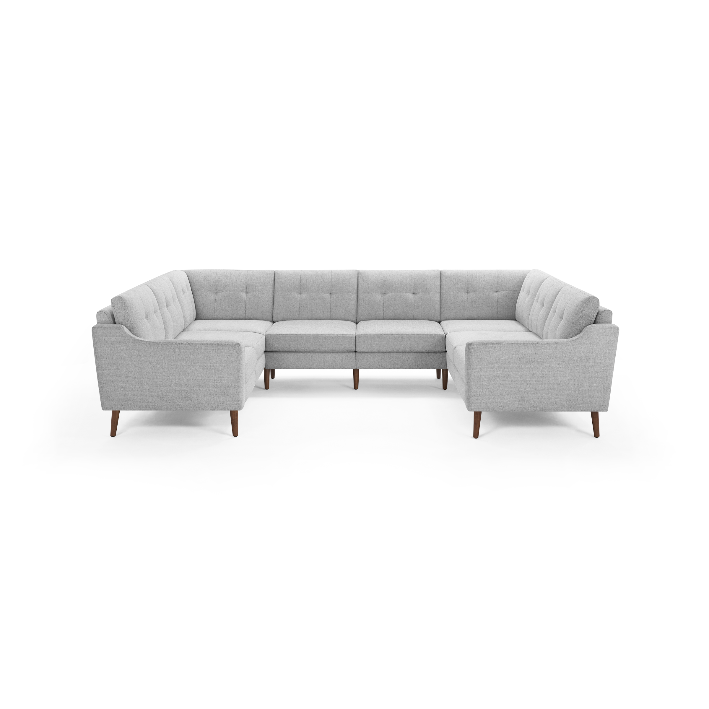 Light gray upholstered U-shaped sectional sofa with tufted back cushions and wooden tapered legs, modern mid-century design.