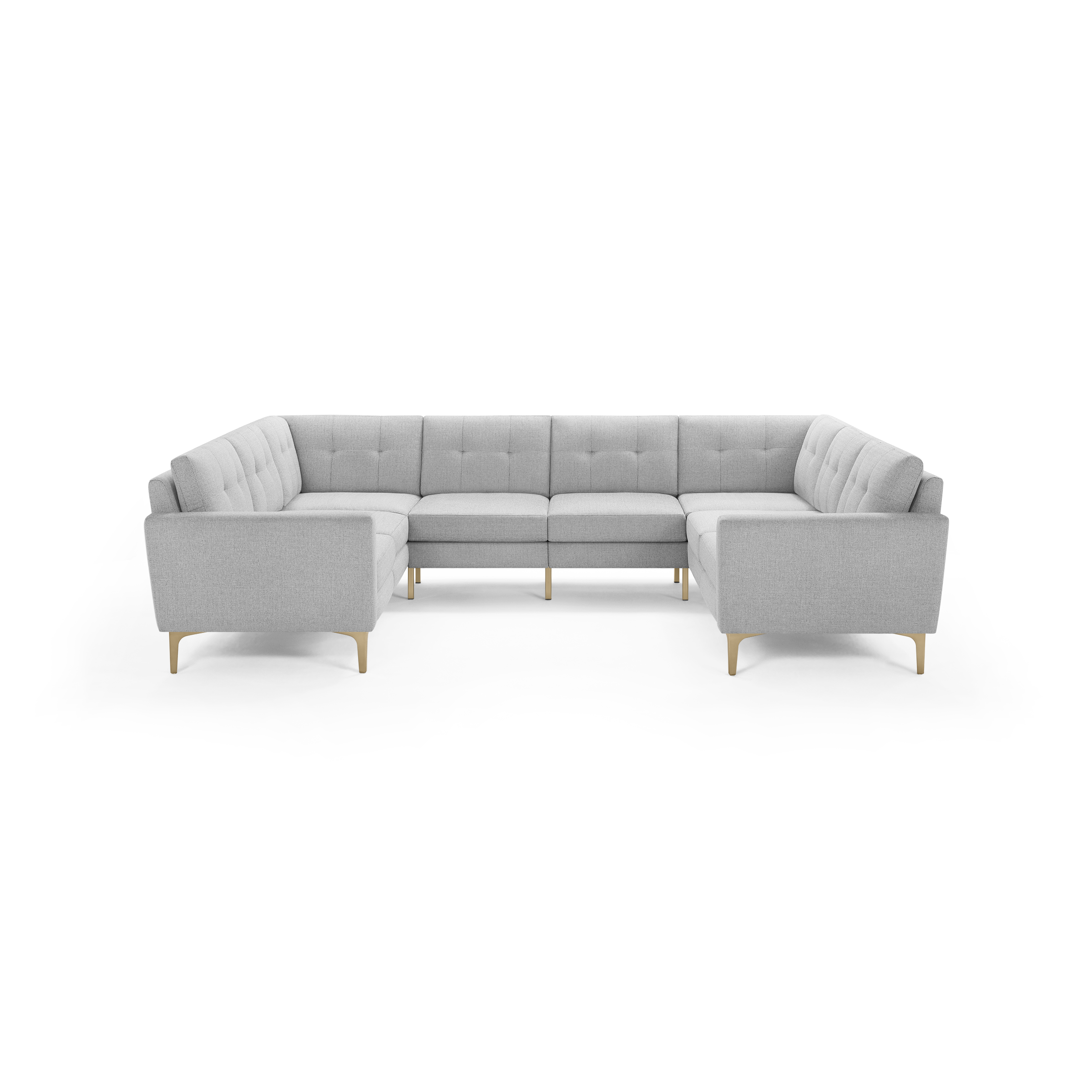 Light gray upholstered U-shaped sectional sofa with tufted back cushions and wooden legs, modern mid-century design.