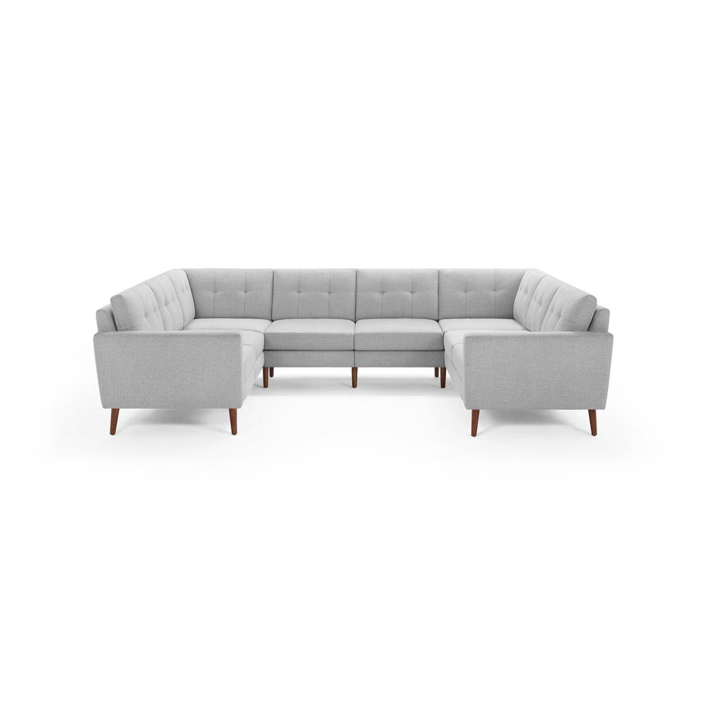 Light gray fabric U-shaped sectional sofa with tufted back cushions and wooden tapered legs, designed for modern living rooms.