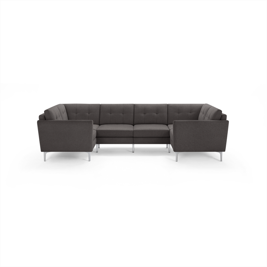 Dark gray fabric U-shaped sectional sofa with tufted back cushions and sleek silver metal legs, modern design.