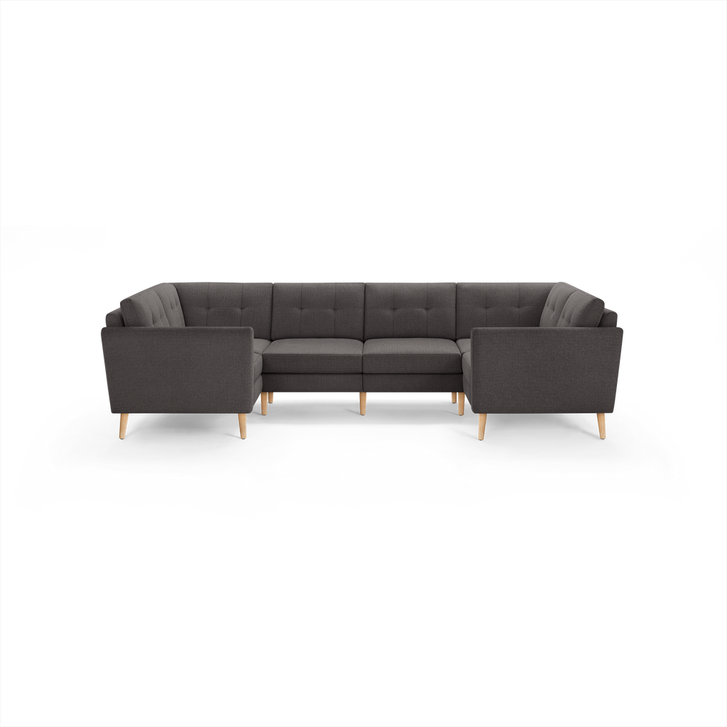 Dark gray fabric U-shaped sectional sofa with tufted back cushions and light wooden legs, designed for spacious seating.