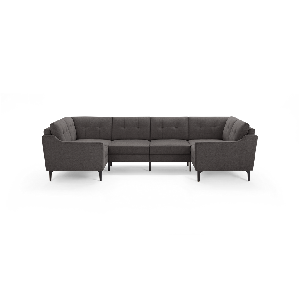 Dark gray fabric U-shaped sectional sofa with tufted cushions, slim armrests, and black metal legs.
