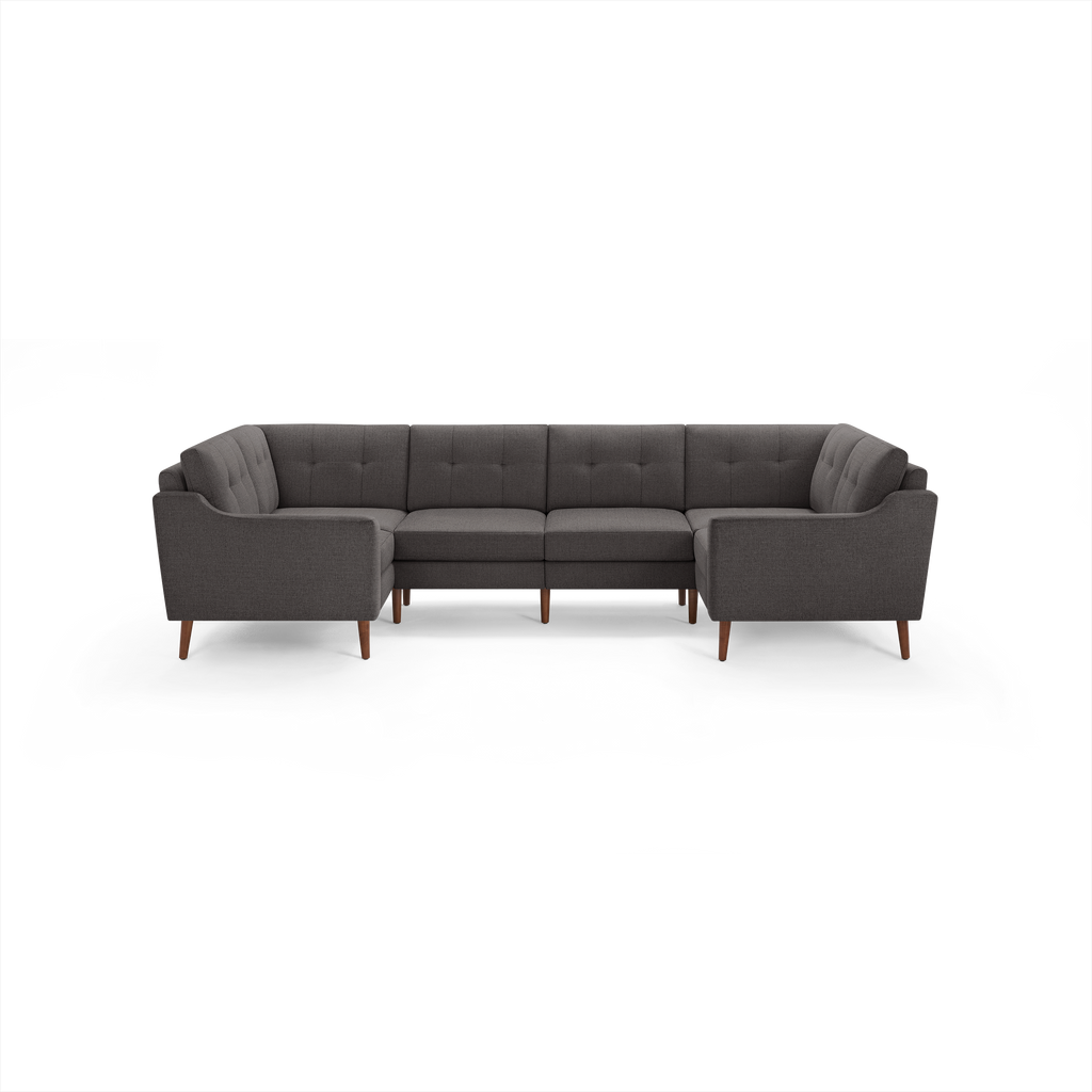 Dark gray fabric U-shaped sectional sofa with tufted backrests and wooden tapered legs, modern mid-century design.