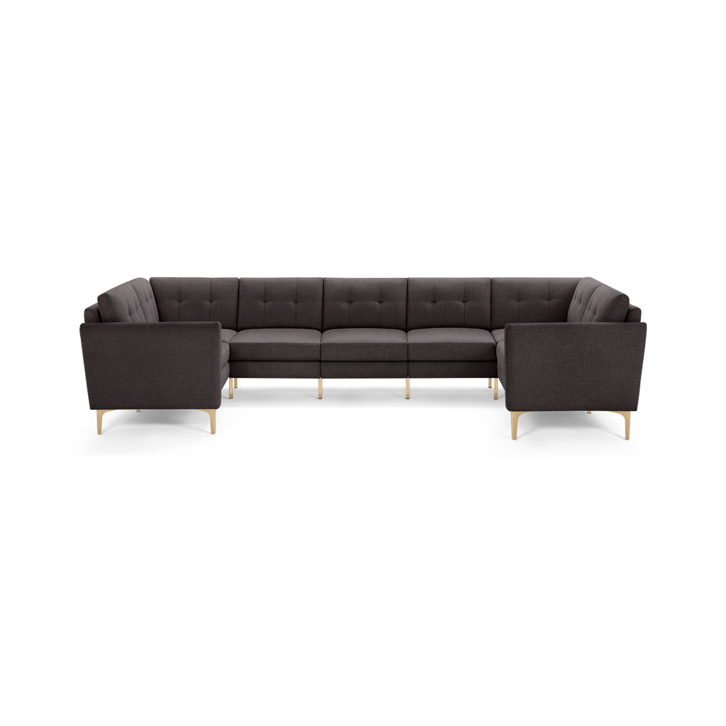 Dark gray L-shaped sectional sofa with tufted back cushions and light wood legs, modern and spacious design.