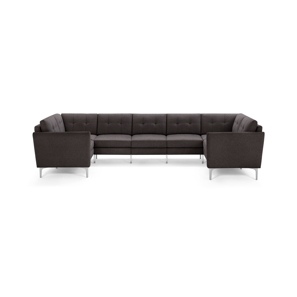 Dark gray fabric sectional sofa with tufted cushions, angular armrests, and sleek metal legs, arranged in a U-shape.