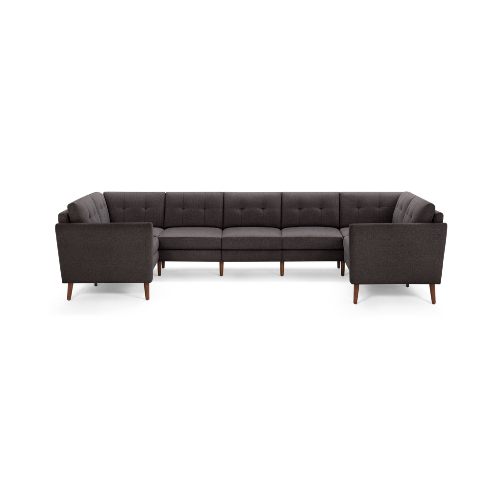 Dark gray tufted fabric sectional sofa with wooden tapered legs, modern design, and right and left armrests.