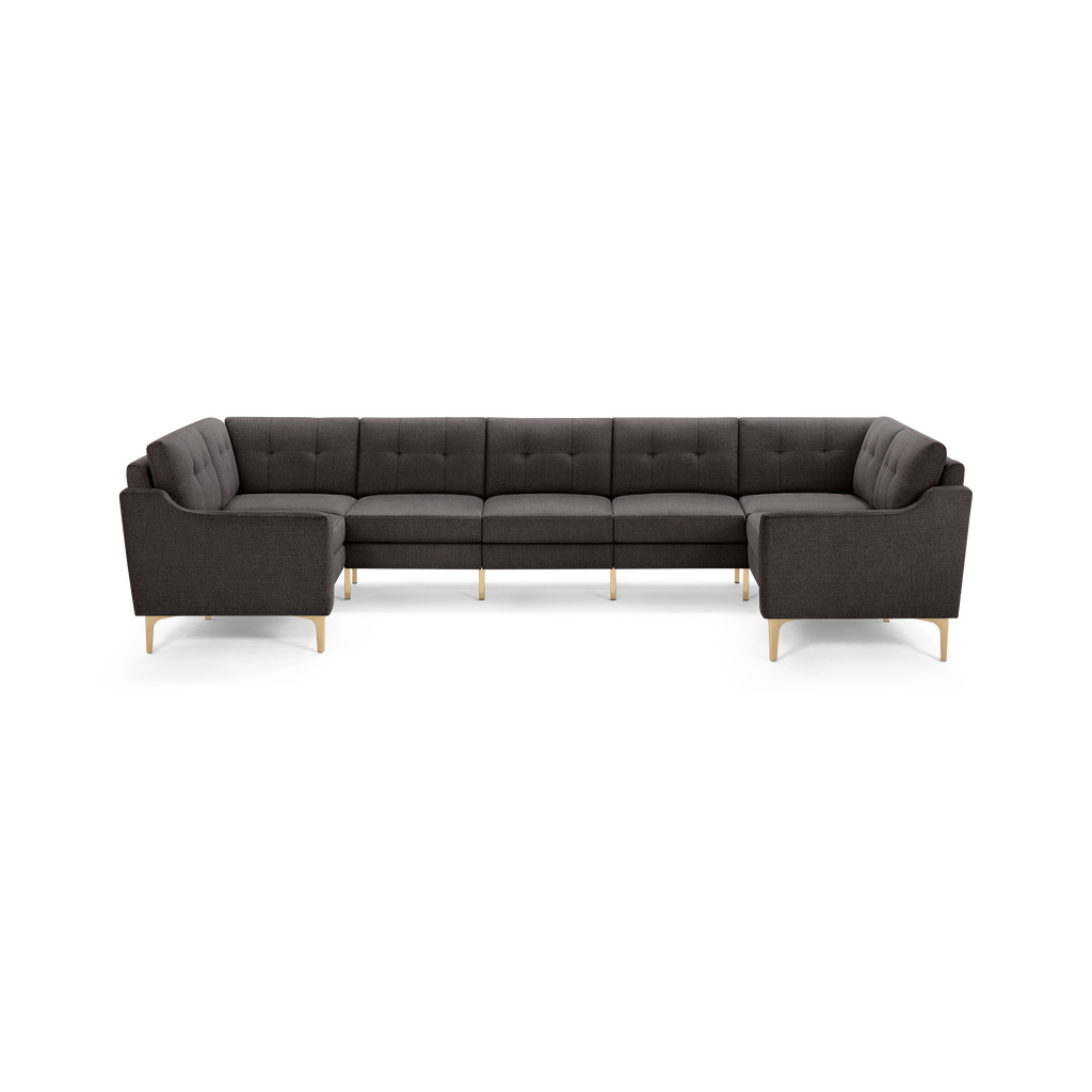 Dark gray L-shaped sectional sofa with tufted back cushions and light wooden legs, designed for spacious and modern living rooms.