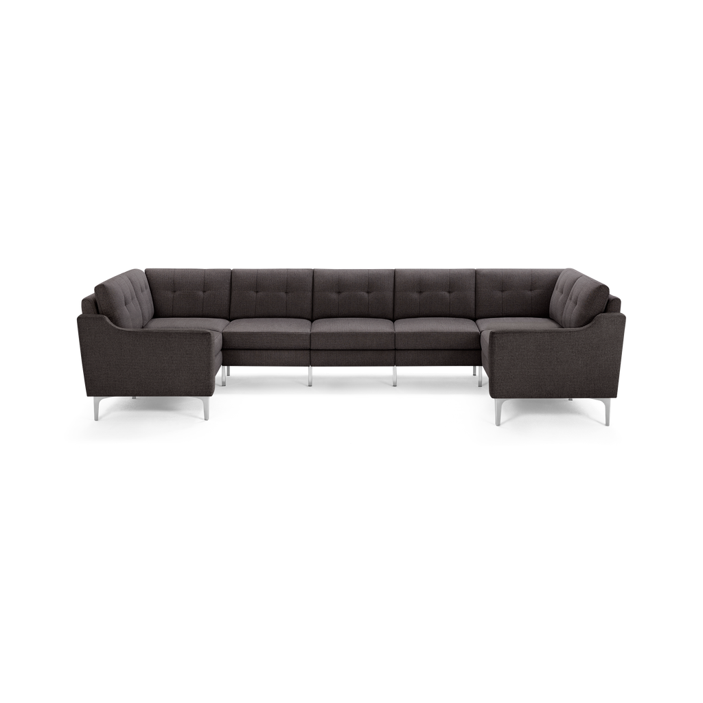 Large dark gray U-shaped sectional sofa with tufted cushions, modern armrests, and silver metal legs on white background.