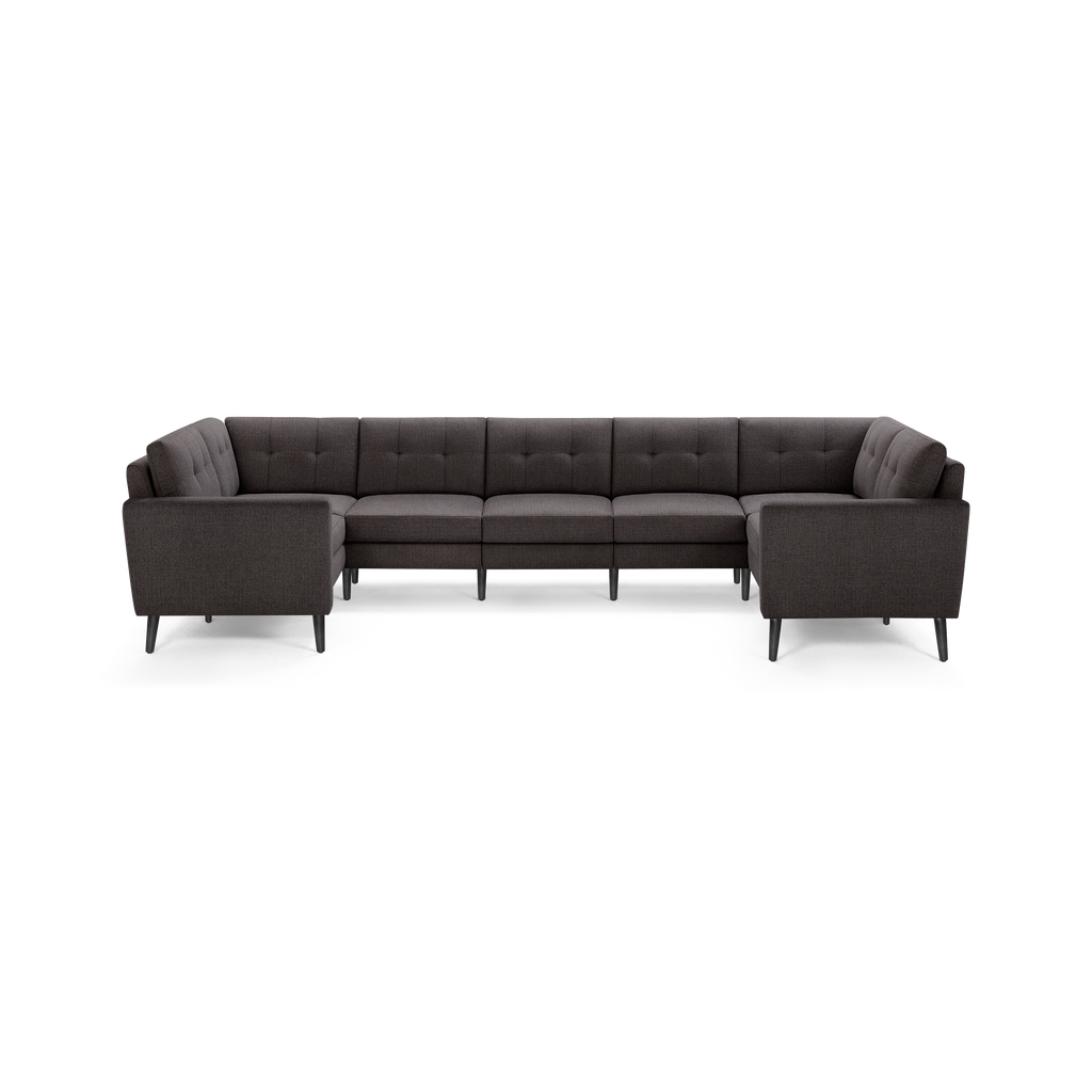 Dark gray fabric U-shaped sectional sofa with tufted backrest and black tapered legs, modern design.
