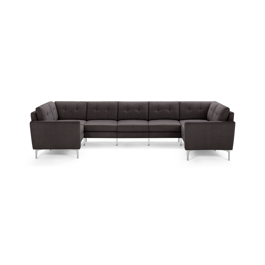 Dark gray L-shaped sectional sofa with tufted back cushions and slim metal legs, designed for modern living spaces.