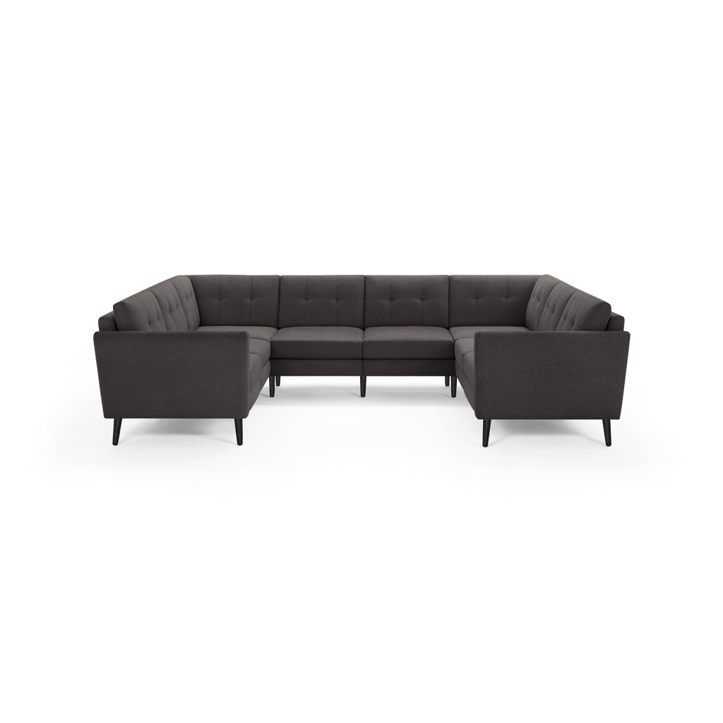 Dark gray fabric U-shaped sectional sofa with tufted back cushions and black tapered wooden legs.