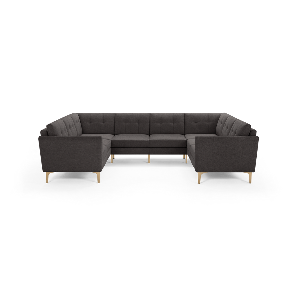 Dark gray upholstered U-shaped sectional sofa with tufted back cushions and light wooden legs.
