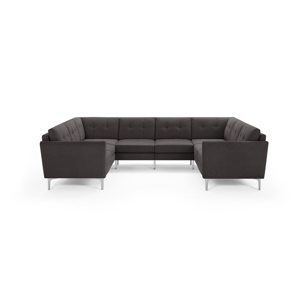 Modern U-shaped sectional sofa with dark gray fabric upholstery, button-tufted cushions, and sleek silver metal legs.