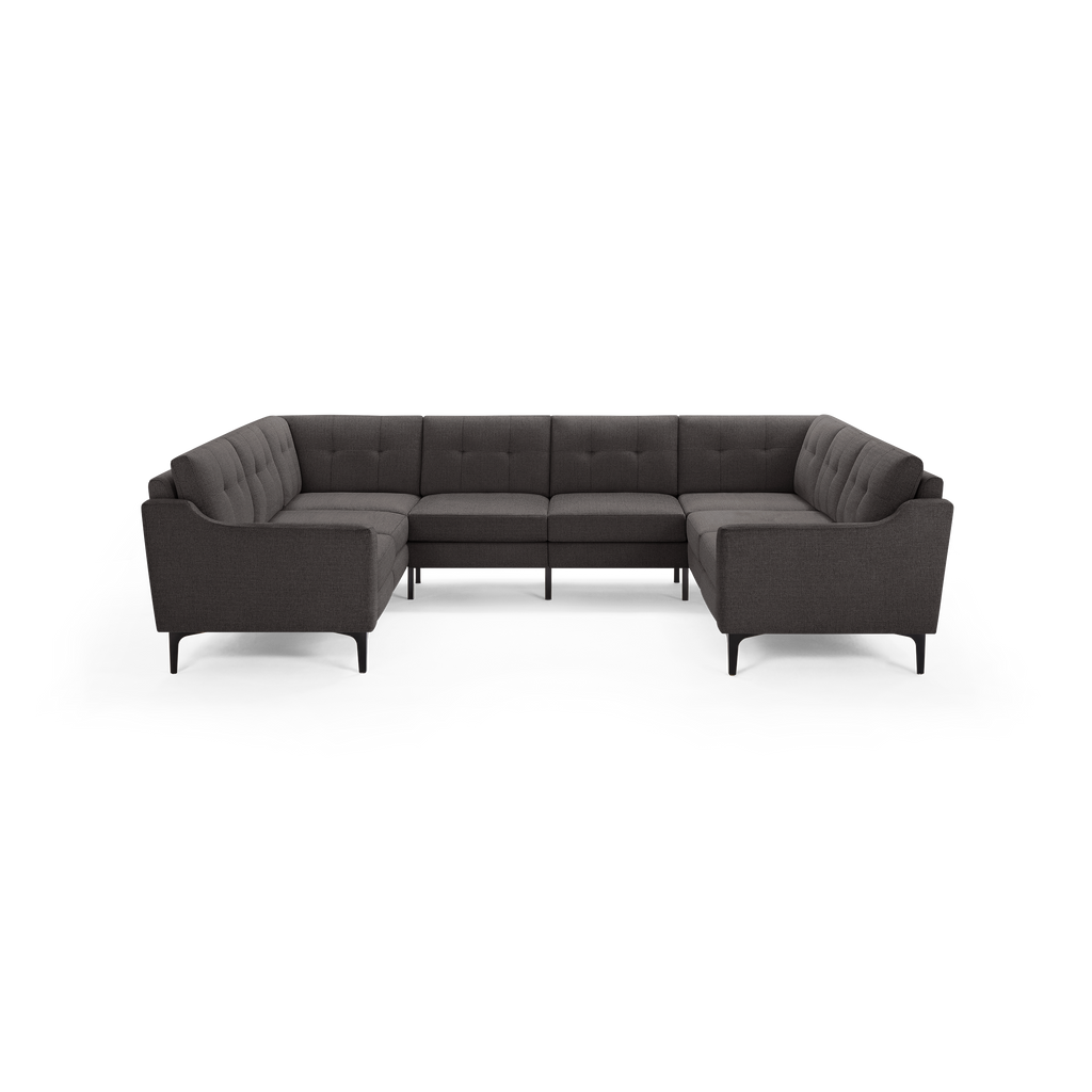 Dark gray modern sectional sofa with tufted cushions, curved armrests, and slim black legs, designed for spacious seating.