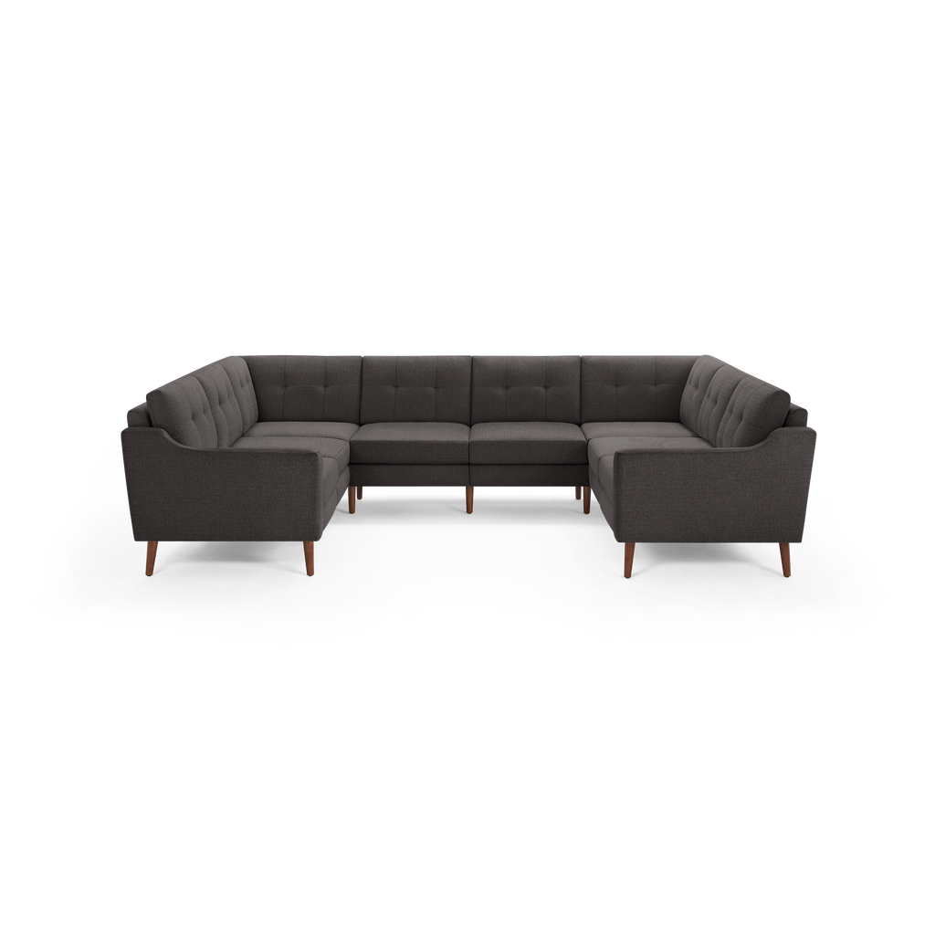 Dark gray U-shaped sectional sofa with tufted back cushions and wooden legs, designed for spacious and comfortable seating.