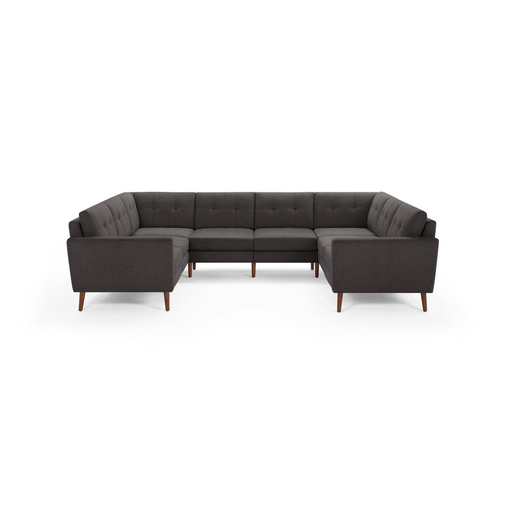 Dark gray fabric U-shaped sectional sofa with tufted back cushions and wooden tapered legs.