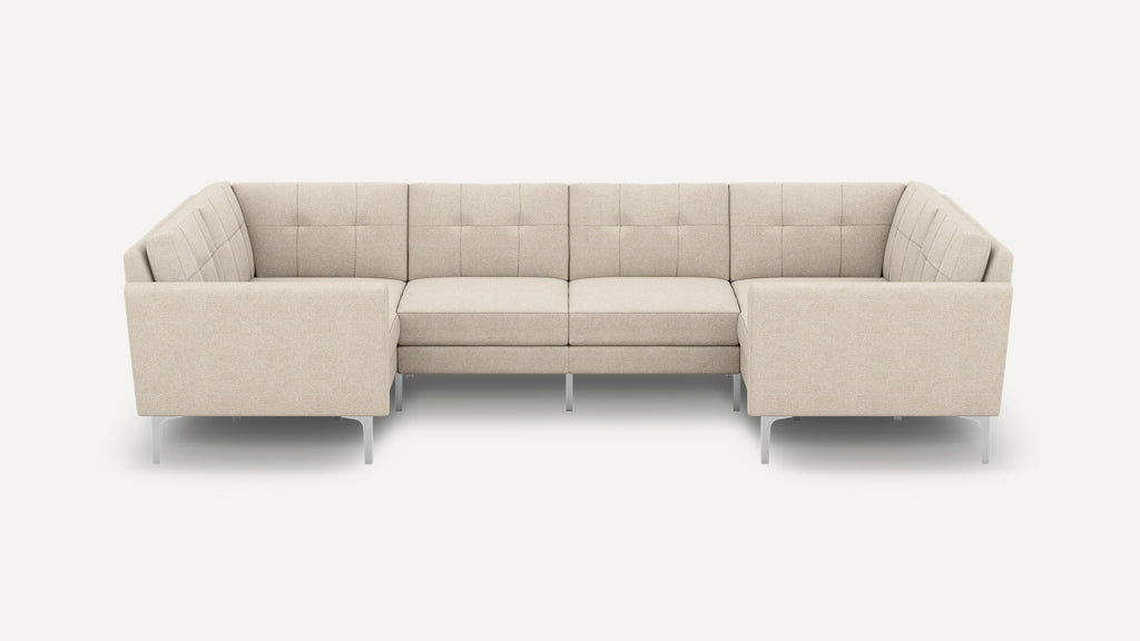 Beige fabric U-shaped sectional sofa with tufted back cushions, slim armrests, and modern metal legs on white background.