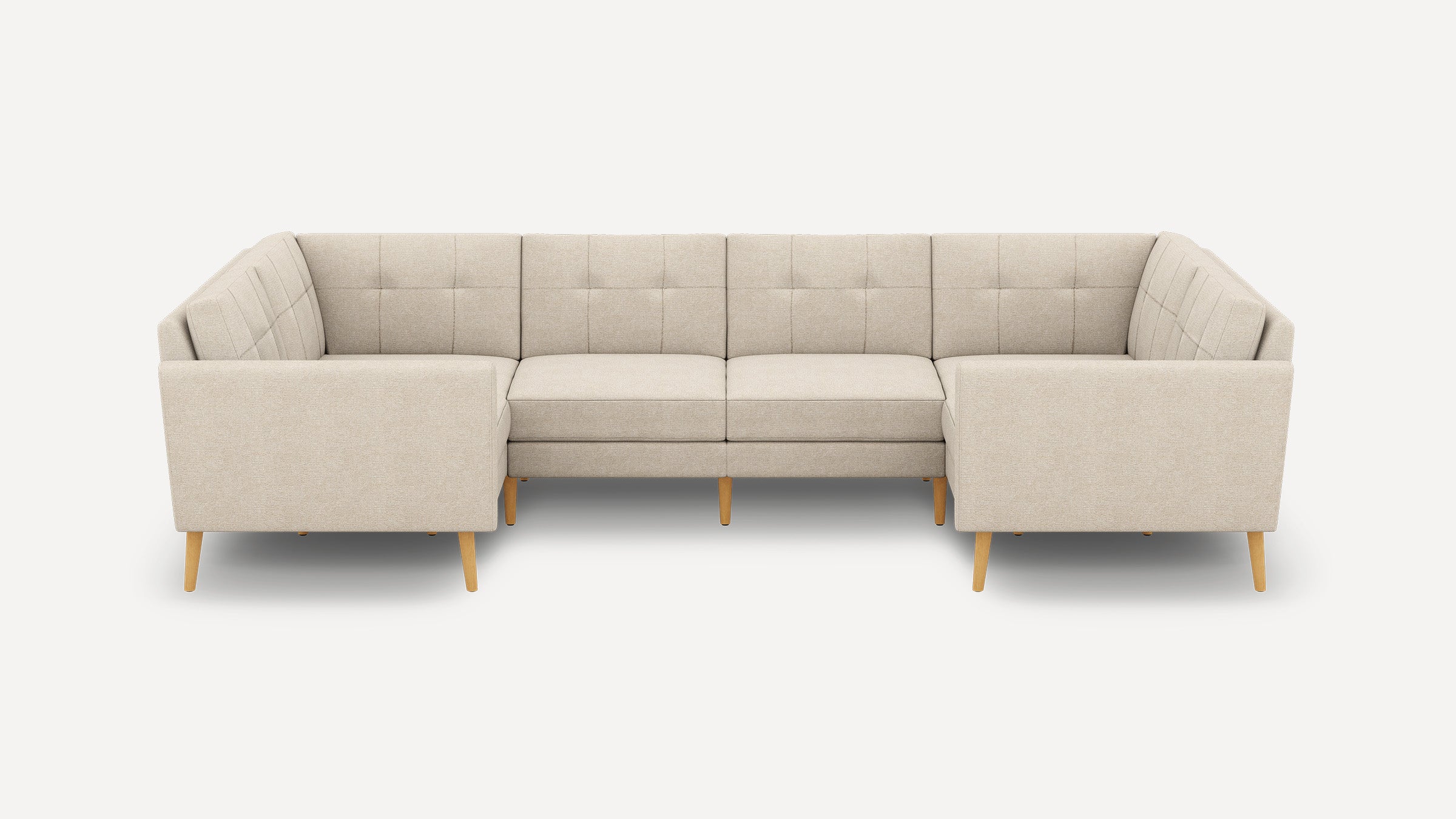 Beige U-shaped sectional sofa with tufted back cushions and wooden tapered legs, designed for spacious seating.