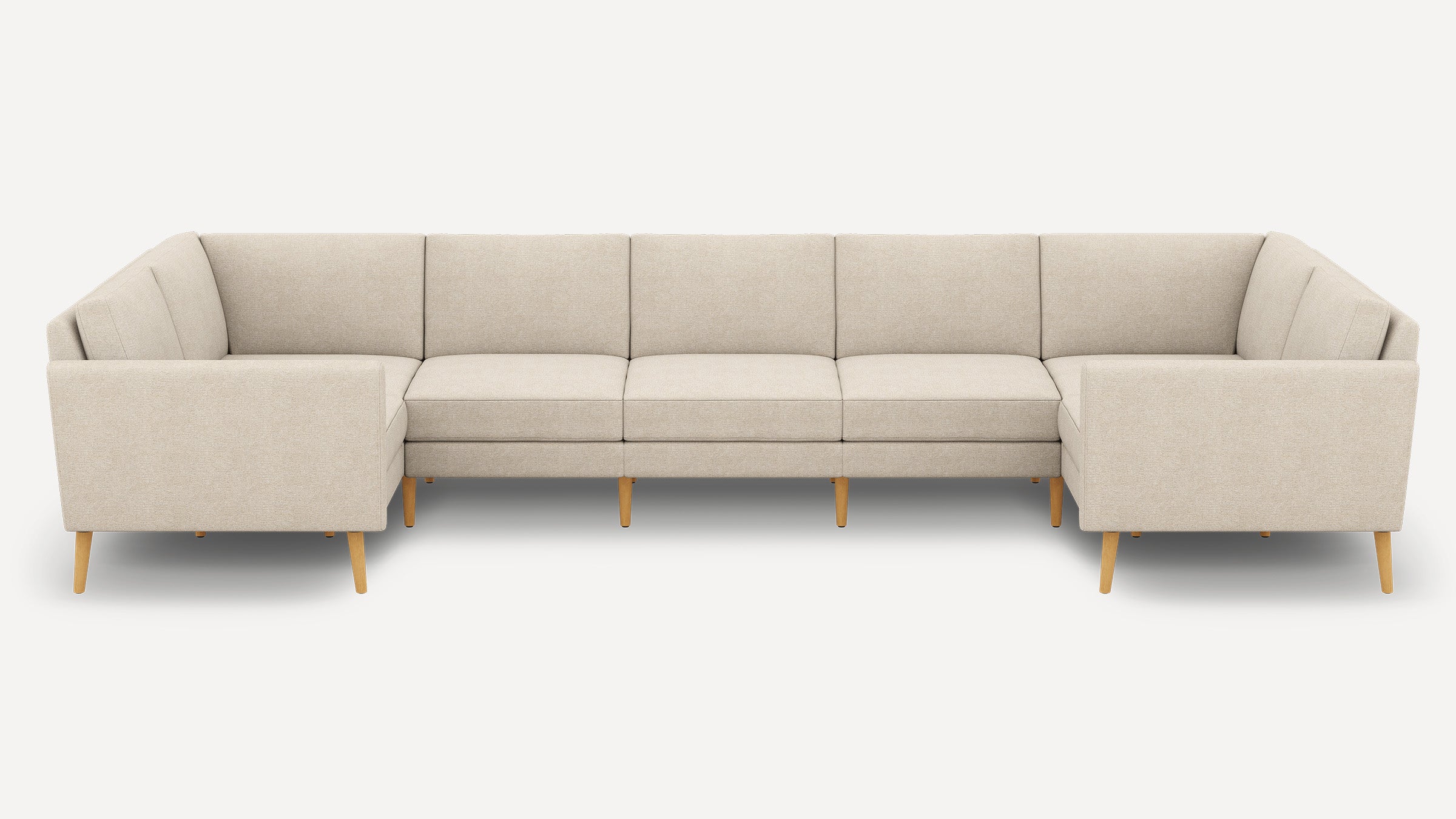 Beige U-shaped sectional sofa with clean lines, tufted cushions, and wooden tapered legs, set against a plain white background.