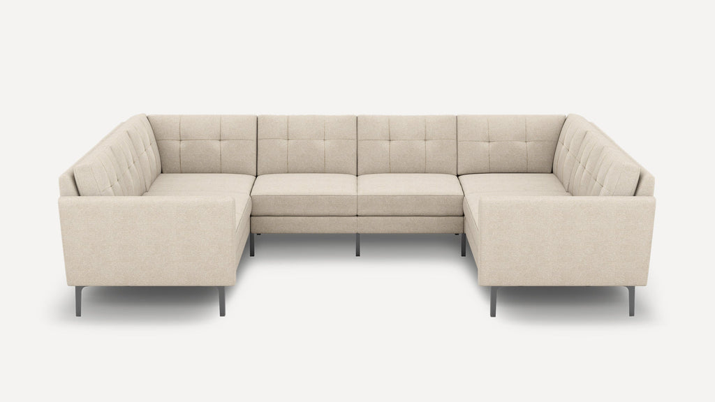 U-shaped beige sectional sofa with tufted back cushions, sleek metal legs, and modern minimalist design.
