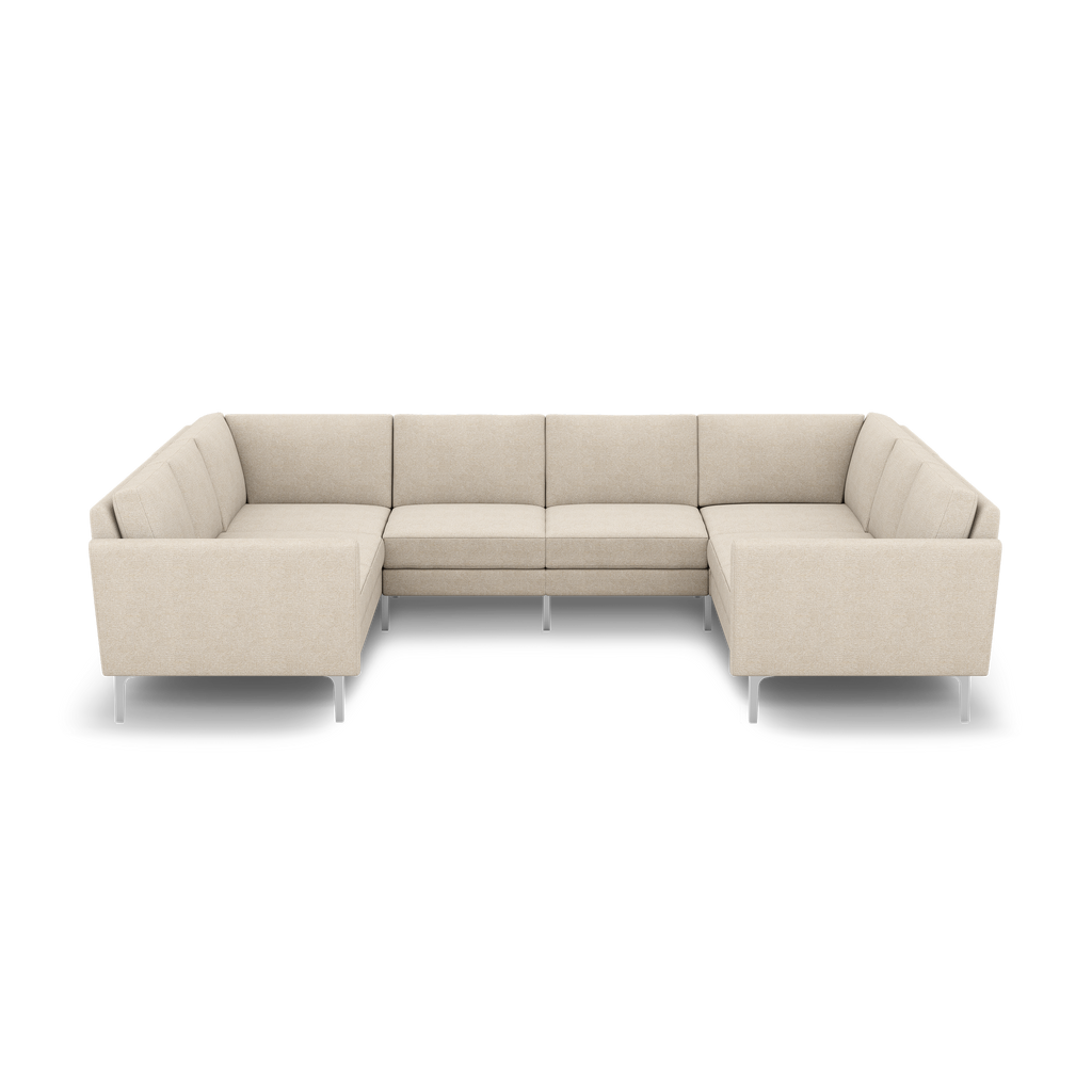 U-shaped beige sectional sofa with clean lines, tufted cushions, and slim metal legs for modern living room seating.