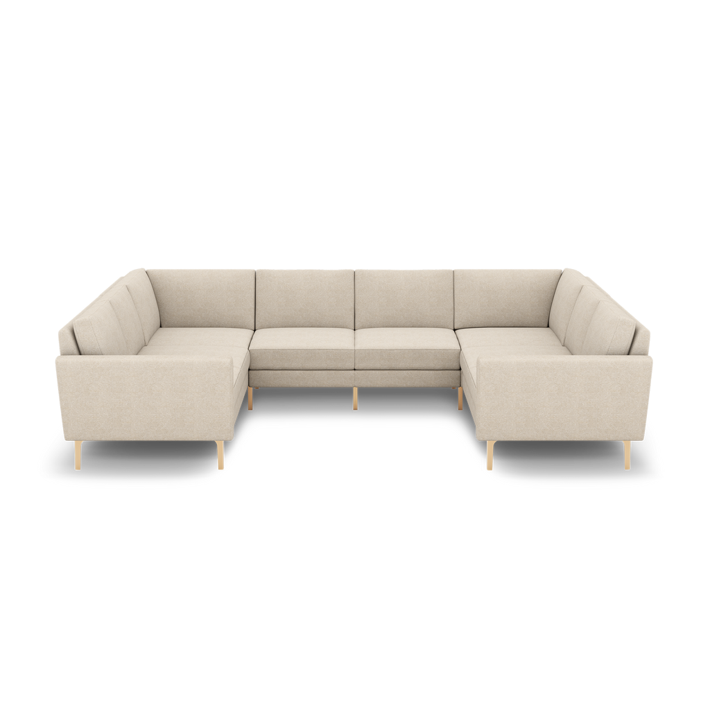 Beige U-shaped sectional sofa with clean lines, cushioned backrests, and wooden legs, designed for spacious seating.
