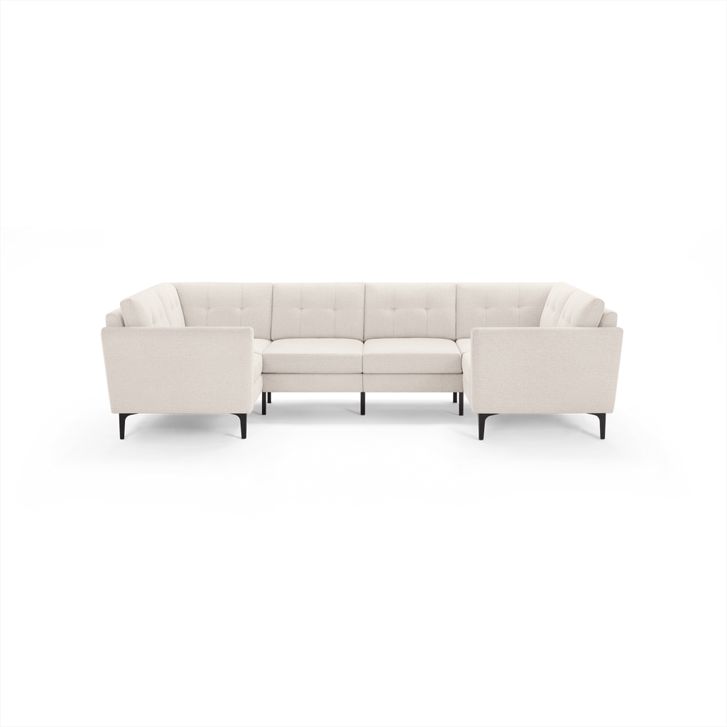 Modern beige fabric U-shaped sectional sofa with tufted back cushions and black tapered legs, designed for spacious seating.