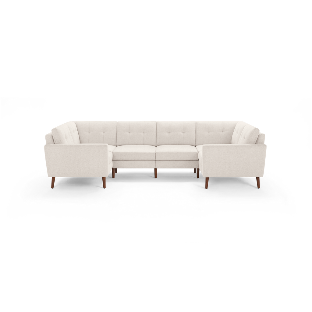 Cream beige upholstered sectional sofa with mid-century wooden legs and a modern tufted backrest design.