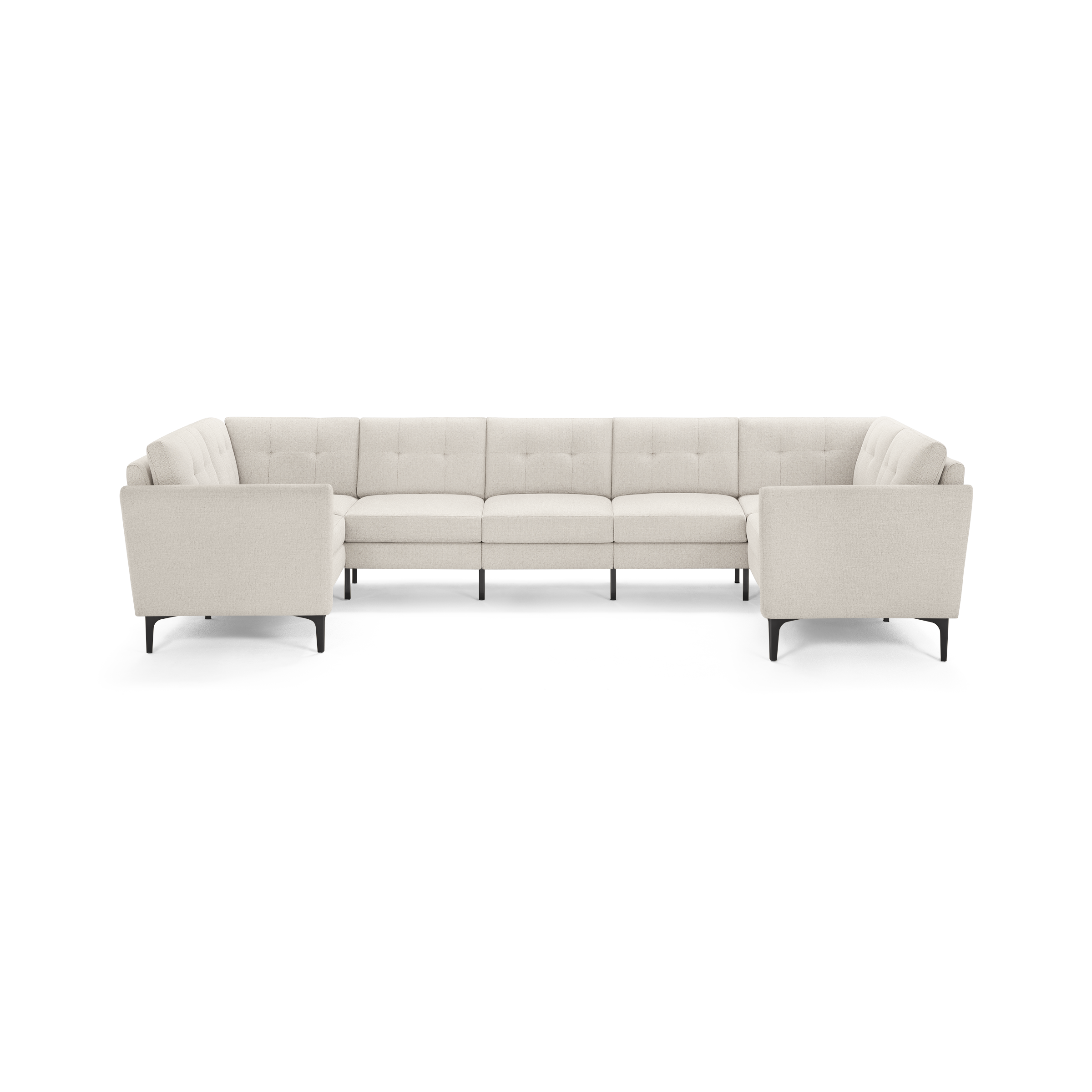 Large modern beige fabric sectional sofa with tufted back cushions, straight armrests, and black metal legs isolated on white background.