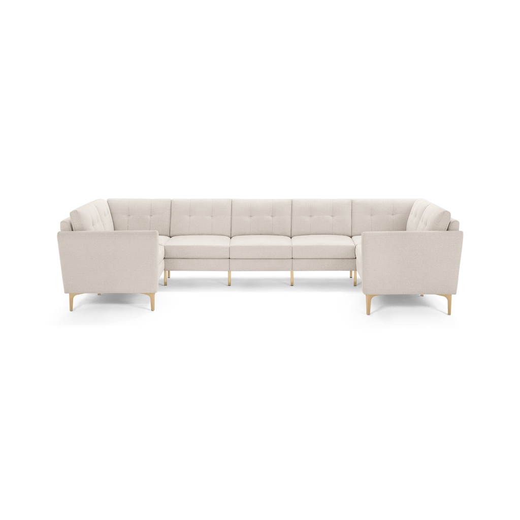Beige modern sectional sofa with tufted cushions and wooden legs, designed for spacious living rooms.