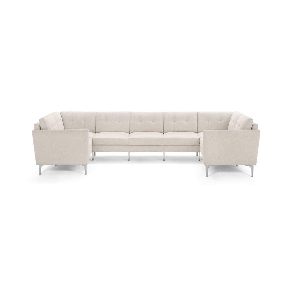 Modern U-shaped sectional sofa with light beige tufted upholstery and slim metal legs, designed for spacious seating.