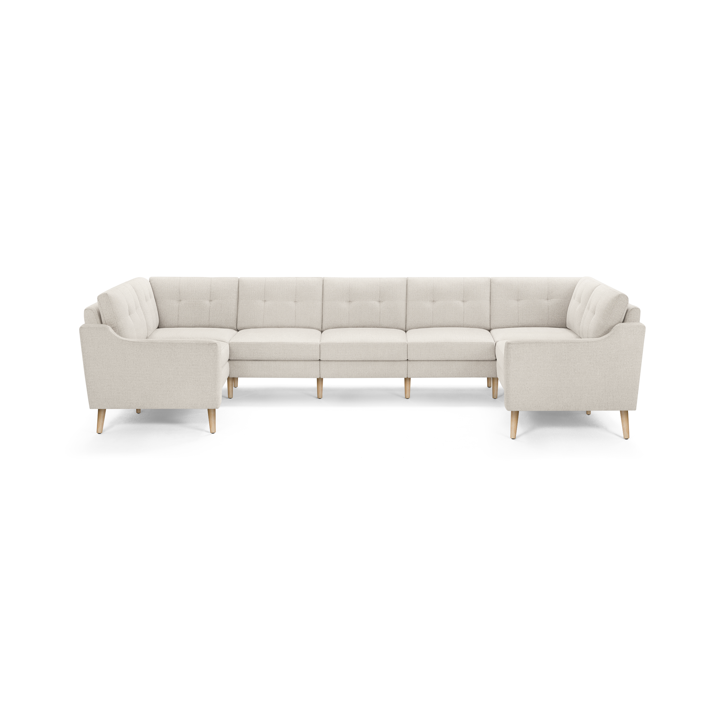 Large U-shaped sectional sofa with light beige fabric upholstery, tufted back cushions, and wooden tapered legs.