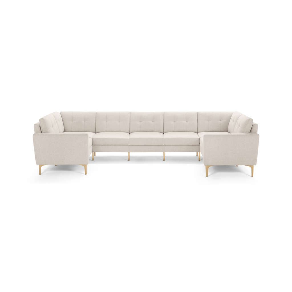Beige modern U-shaped sectional sofa with tufted cushions and light wooden legs, designed for spacious seating.