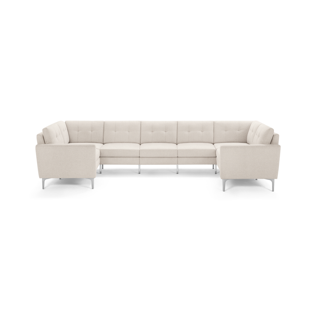 Beige fabric U-shaped sectional sofa with tufted cushions and slim metal legs, designed for spacious seating.