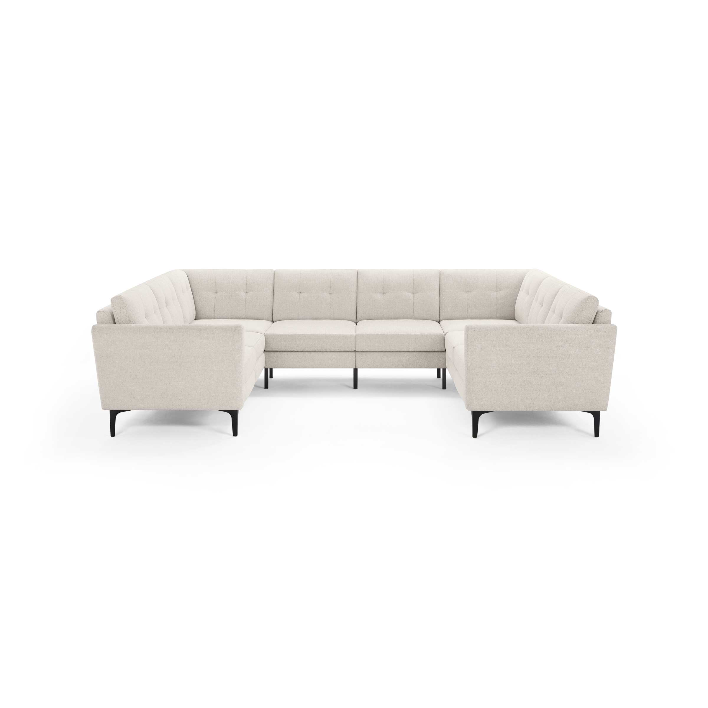 Modern large U-shaped sectional sofa in light beige fabric with tufted back cushions and slim black legs.