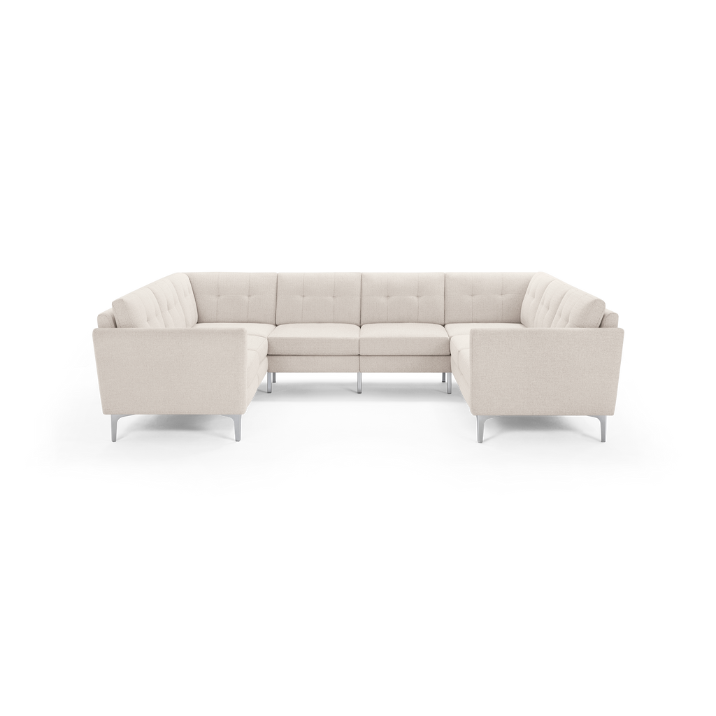 Beige fabric U-shaped sectional sofa with tufted back cushions and sleek metal legs, designed for spacious seating.