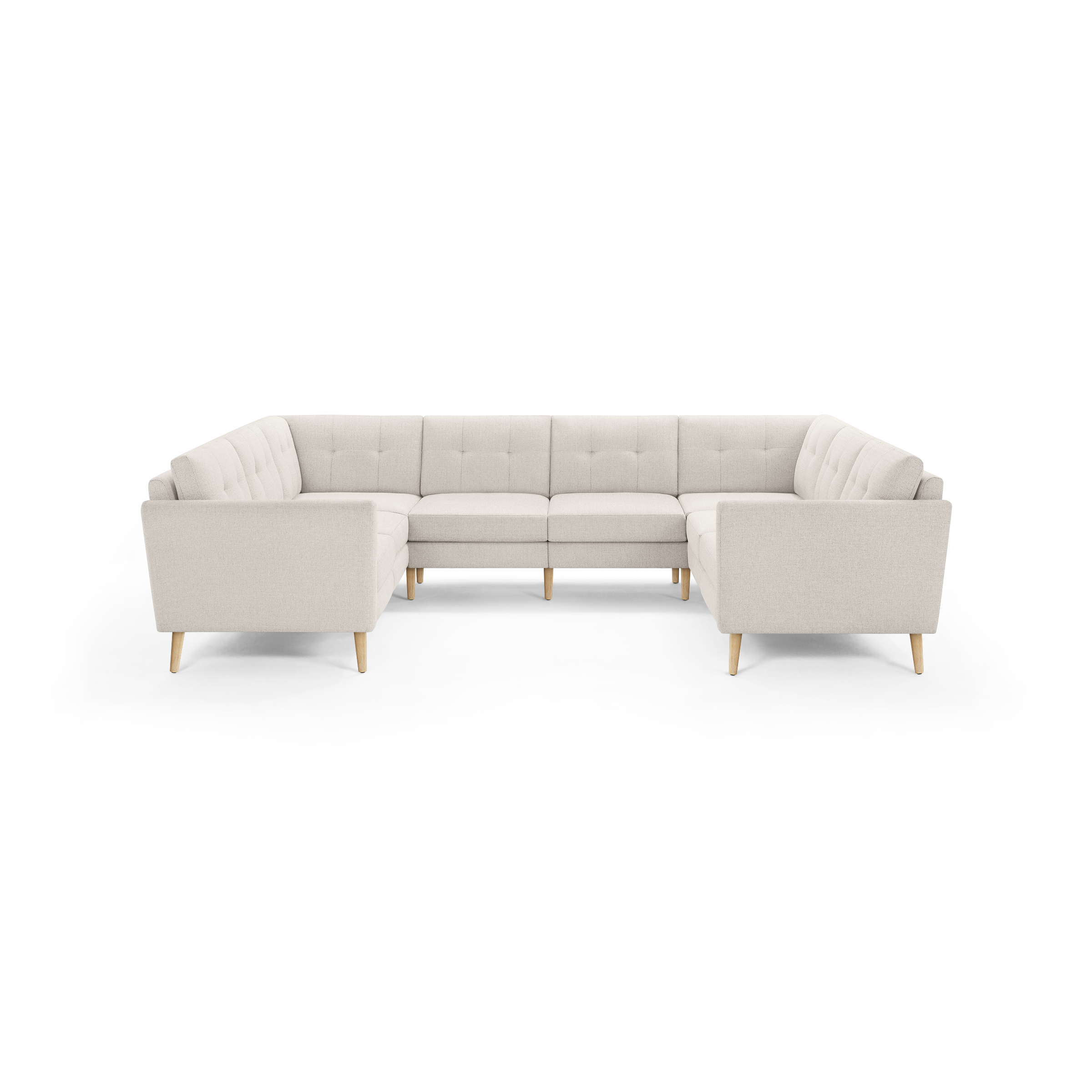 Beige upholstered modular U-shaped sectional sofa with tufted back cushions and light wooden legs, viewed from the front.