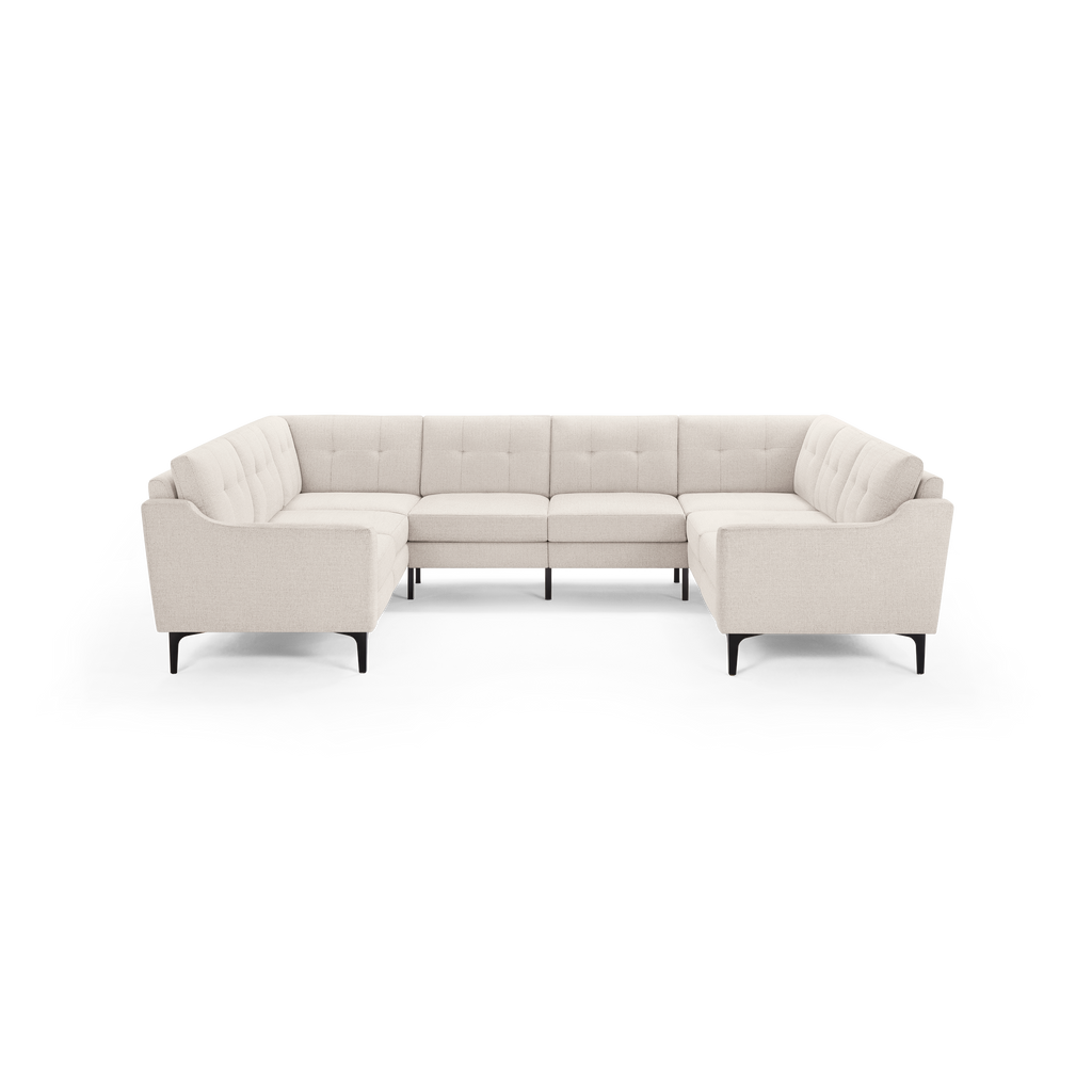 Cream-colored modern U-shaped sectional sofa with button-tufted cushions and black metal legs.