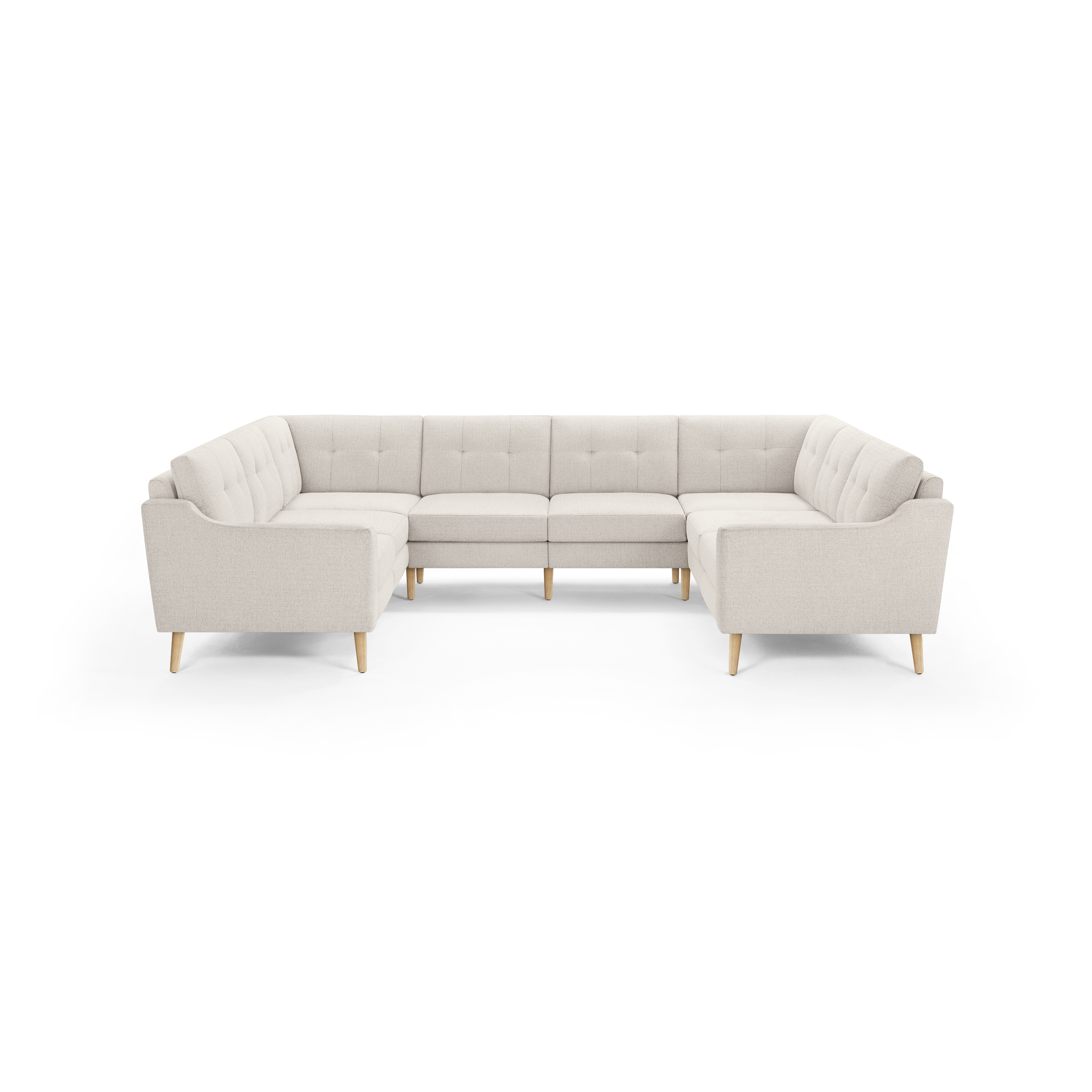 Large U-shaped sectional sofa in light beige fabric with tufted backs and light wooden legs on black background.