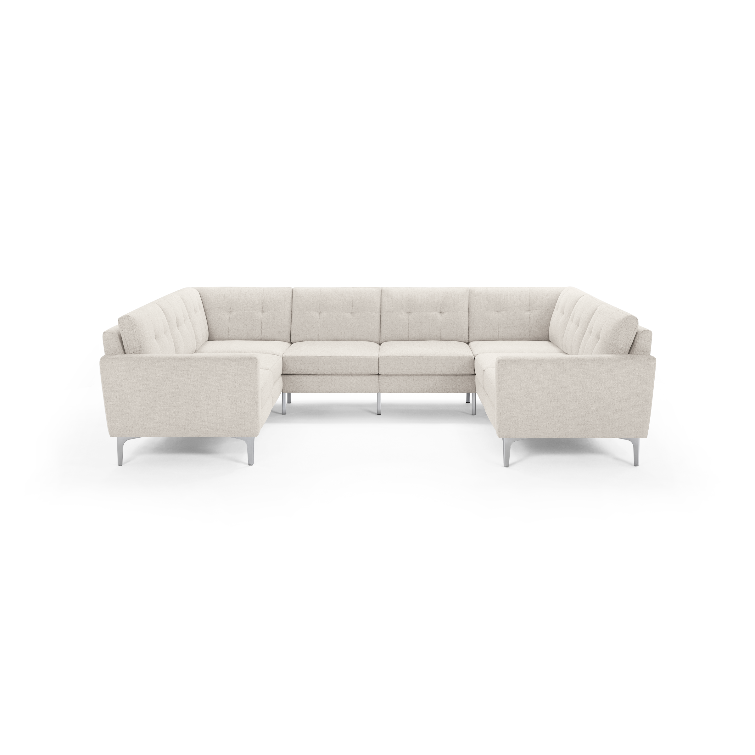 U-shaped sectional sofa in light beige fabric with tufted cushions and slim silver metal legs.