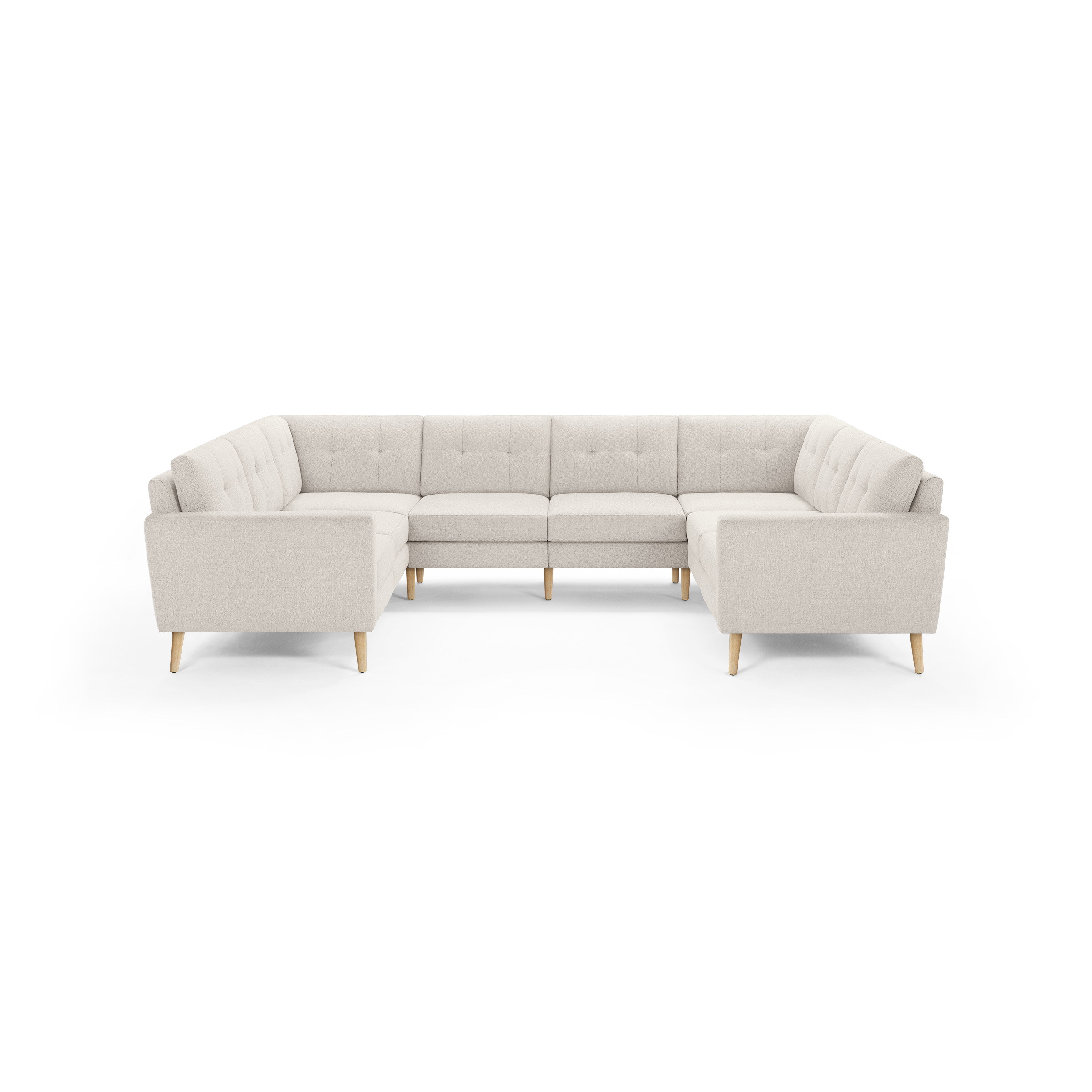 Light beige large U-shaped sectional sofa with tufted cushions and wooden legs, designed for spacious living rooms.