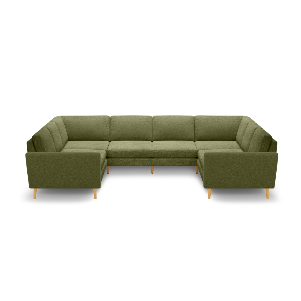 Large olive green U-shaped sectional sofa with clean lines, tufted back cushions, and natural wood tapered legs, isolated on black background.