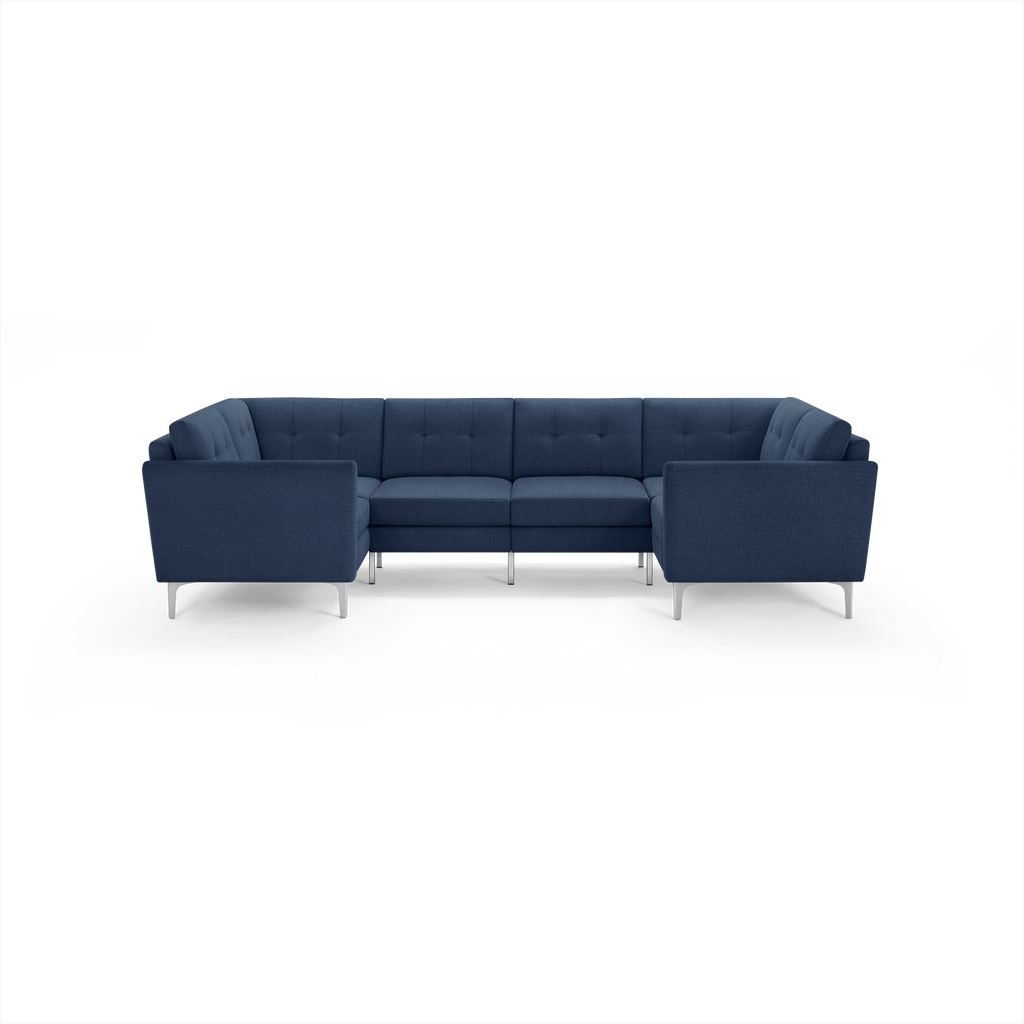 Modern L-shaped sectional sofa with deep blue fabric upholstery, tufted back cushions, and sleek silver metal legs.