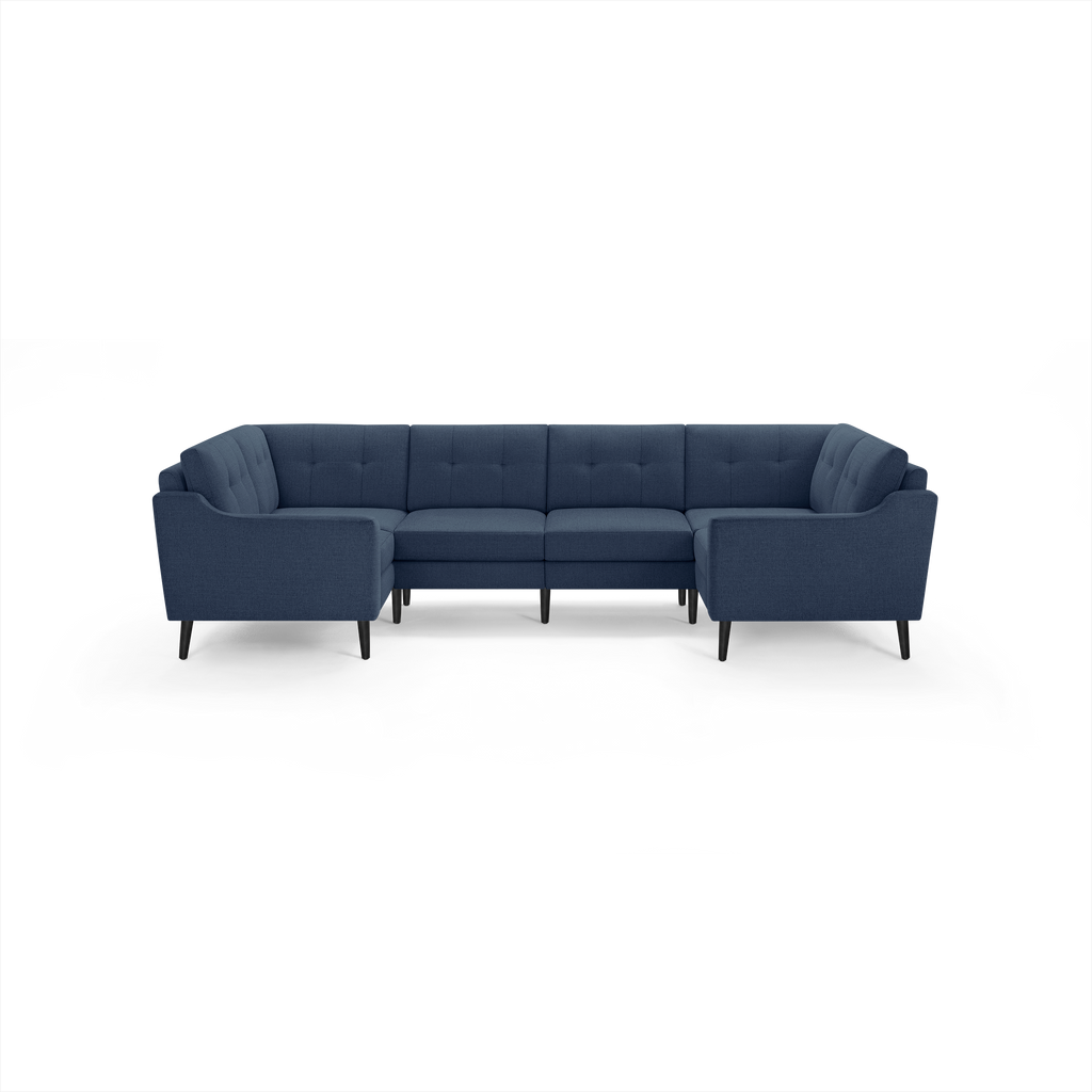 Modern navy blue fabric U-shaped sectional sofa with tufted cushions and slim black wooden legs.