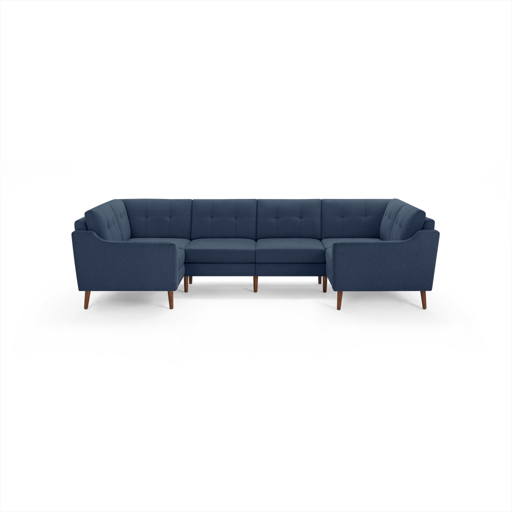Modern navy blue fabric sectional sofa with tufted backrests and wooden legs, designed for spacious corner seating.