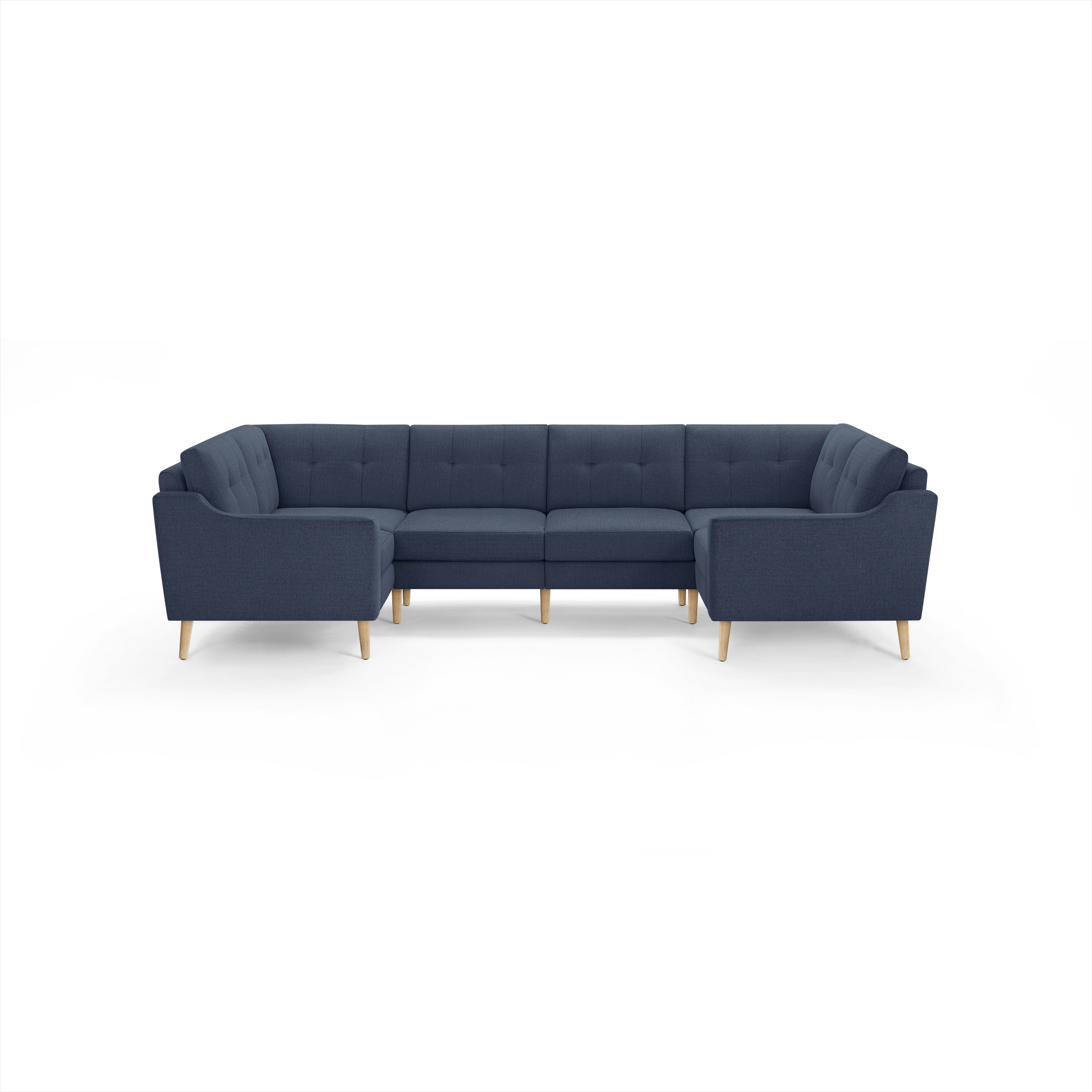 Large U-shaped sectional sofa upholstered in dark blue fabric with tufted back cushions and light wooden legs.