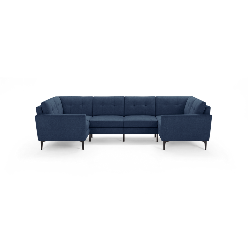 Modern navy blue fabric sectional sofa with tufted back cushions and black tapered legs, arranged in a U-shape.